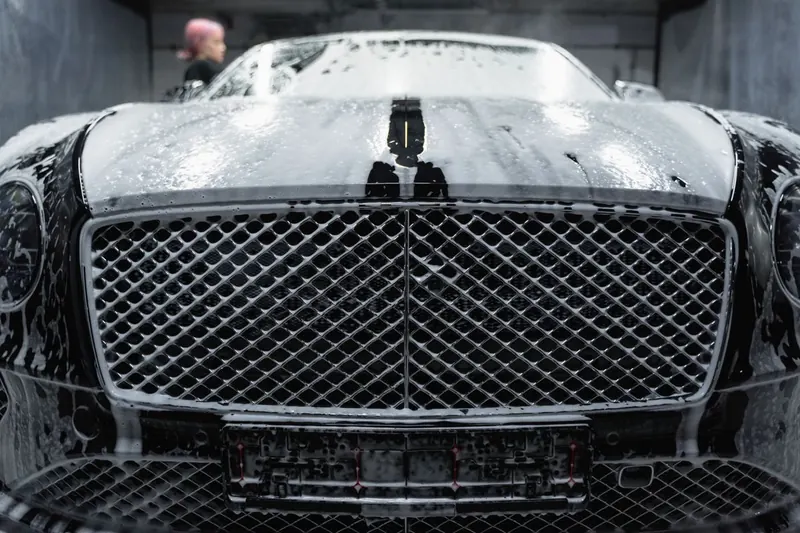 Car covered in snow foam during a pre-wash
